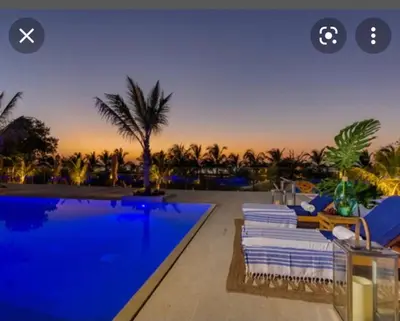 a swimming pool with chairs and a resort with palm trees at MORROS EPIC luxury beach in Cartagena de Indias