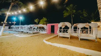 a row of chairs on the beach at night at Marbelo Coveñas by Bernalo Hotels in Coveñas