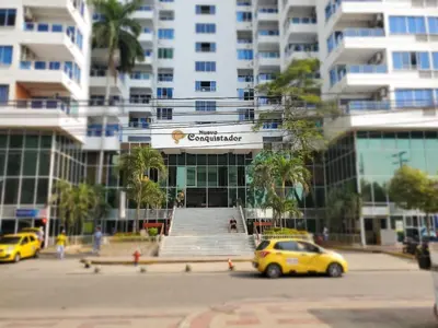 a yellow car parked in front of a building at Shark 1514 Nuevo Conquistador in Cartagena de Indias