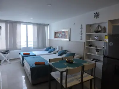 a living room with a couch and a table at Estudio Loft Cartagena in Cartagena de Indias
