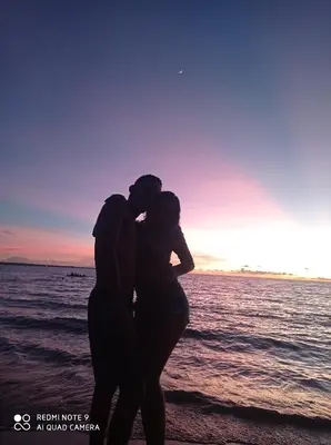 a man and a woman standing on the beach at HOSTAL BELLEZA TROPICAL in Moñitos