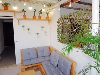 a couch in a room with plants on the wall at Apto en Getsemani el barrio mas cool de Cartagena in Cartagena de Indias