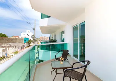 a balcony with two chairs and a table at Playa Norte Hotel in Cartagena de Indias