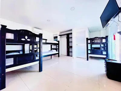 a room with three bunk beds in a room at Playa Norte Hotel in Cartagena de Indias