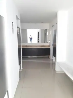 a person taking a picture of a bathroom in a building at Rincon 94- Barranquilla- Rio Alto in Barranquilla
