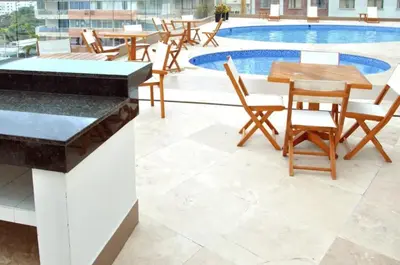 a patio with tables and chairs next to a pool at Apartamento Palmetto Eliptic - Best Seaview in Cartagena de Indias