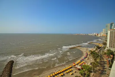 an aerial view of a beach with umbrellas and the ocean at Apartamento Palmetto Eliptic - Best Seaview in Cartagena de Indias