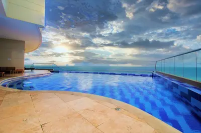 a swimming pool on top of a building with the ocean at Apartamento Palmetto Eliptic - Best Seaview in Cartagena de Indias