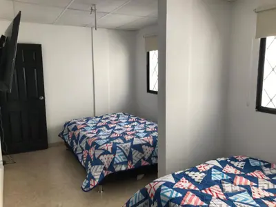 a bedroom with two beds in a room at CABAÑA LAS MARIAS, Climatizada, Piscina y BBQ in Santa Marta