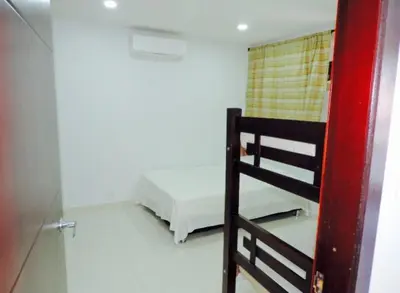 a bedroom with a bunk bed and a ladder at Cristoforo Oasis in Cartagena de Indias
