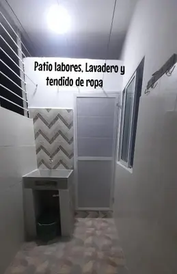 a bathroom with a sink and a desk in a room at Apartamento JHON in Coveñas