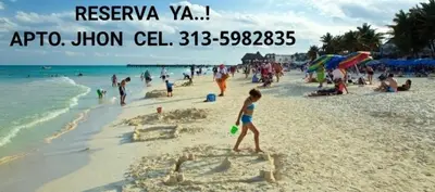 a young girl walking on a beach at Apartamento JHON in Coveñas