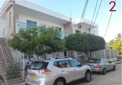 a white car parked in front of a house at Apartamento JHON in Coveñas