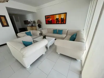 a living room with white couches and blue pillows at Vista directa al mar con amplia terraza y 3 habitaciones in Cartagena de Indias