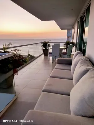 a living room with a couch and a view of the ocean at Loft de Lujo - Wifi, piscina y mar in Santa Marta