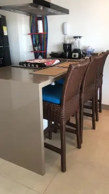 a dining room table with chairs and a counter top at Loft de Lujo - Wifi, piscina y mar in Santa Marta