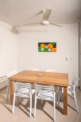 a dining room with a wooden table and chairs at Magico Apartamento Frente al Mar 2 Habitaciones B22B in Coveñitas