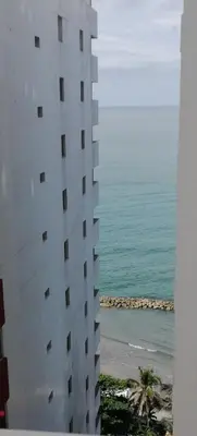 a tall white building next to the ocean at Cómodo Apartamento en Bocagrande Cartagena 1503 in Cartagena de Indias