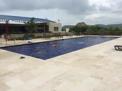 a person swimming in a swimming pool at Casa de Playa en Marina Puerto Velero in Barranquilla