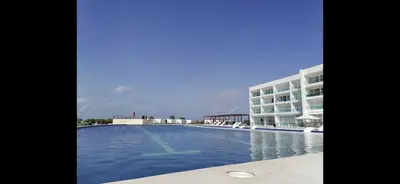a large swimming pool in front of a building at Casa de Playa en Marina Puerto Velero in Barranquilla