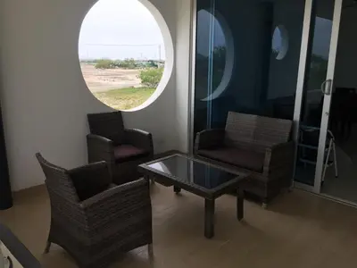 a living room with two chairs and a coffee table at Casa de Playa en Marina Puerto Velero in Barranquilla