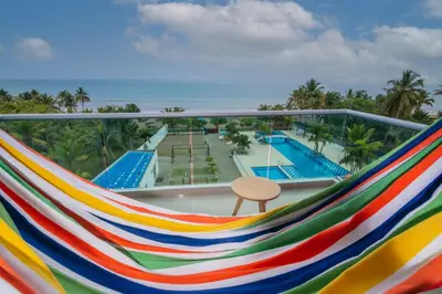a room with a hammock overlooking a pool at Magico Apartamento Frente al Mar 3 Habitaciones AR44 in Coveñas