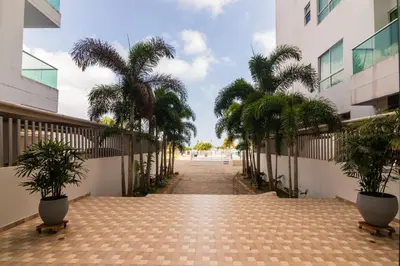 a hallway with palm trees in a building at Magico Apartamento Frente al Mar 3 Habitaciones AR44 in Coveñas