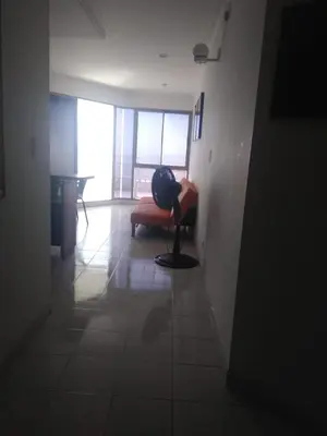 a living room with a chair and a lamp in it at Vista al mar en Edificio Mar Adentro Bocagrande in Cartagena de Indias