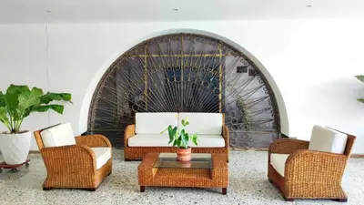 a living room with a couch and two chairs and a table at APARTA-SUITES EN CARTAGENA JUNTO a LA PLAYA in Cartagena de Indias