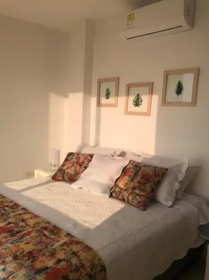 a bedroom with a large bed with pillows on it at NUEVO PRECIOSO APARTAMENTO in Cartagena de Indias