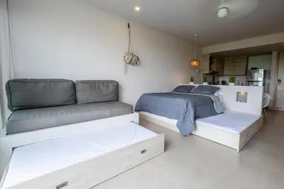 a bedroom with two beds and a couch at Morros ío Serena Del Mar - RNT 95283-523 in Cartagena de Indias