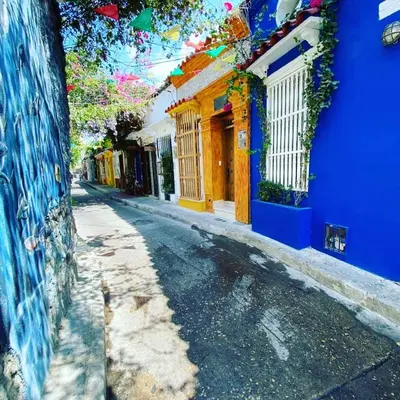 an empty street with blue and yellow buildings at Casa Azulita RNT# 64888 in Cartagena de Indias