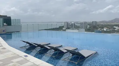 a swimming pool with lounge chairs on top of a building at Spiaggia di Cartagena primera línea de playa in Cartagena de Indias