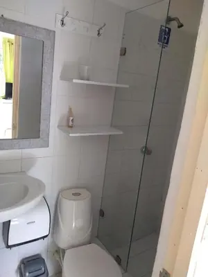 a bathroom with a shower and a toilet and a sink at House Marfito Airport in Cartagena de Indias