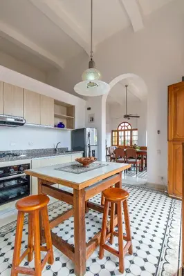 a kitchen with a wooden table and two stools at Casa Morales Getsemaní in Cartagena de Indias