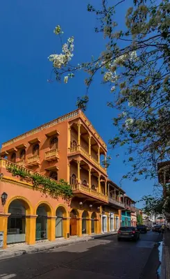 a large orange building with balconies on a street at Casa Morales Getsemaní in Cartagena de Indias