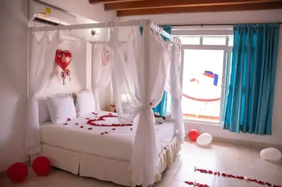 a bedroom with a bed with a red heart on it at hotel 3 banderas Manzanillo del Mar in Cartagena de Indias