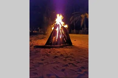 a dress on the beach with fire in it at PLAYA BLANCA SANANTERO CORDOBA las palmeras D’JC in San Antero