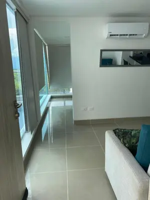 a living room with a couch and a window at Apartamento dentro del Hotel Sonesta Cartagena, aprovecha estar en lo mejor de MORROS in Cartagena de Indias