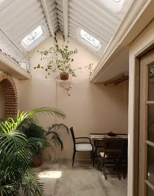 a dining room with a table and chairs and skylights at GREAT LOCATION ! 4 Bedroom Home in the Heart of Cartagena in Cartagena de Indias