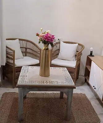 a vase with flowers on a table in a living room at GREAT LOCATION ! 4 Bedroom Home in the Heart of Cartagena in Cartagena de Indias