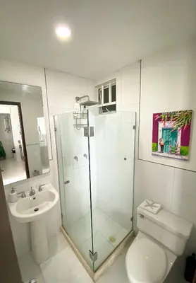 a bathroom with a shower and a toilet and a sink at Apartamento Cartagena en Morros frente a la playa in Cartagena de Indias