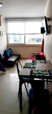 a living room with a table and a couch at Apto Nacaela-Bocagrande cerca a la playa in Cartagena de Indias