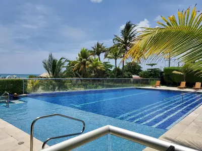 a swimming pool in a resort with palm trees at Morros Vitri memorable in Cartagena de Indias