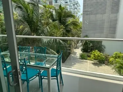 a balcony with a table and chairs and palm trees at Morros Vitri memorable in Cartagena de Indias