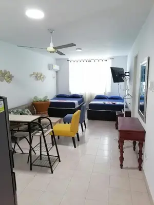 a hospital room with beds and a table and chairs at apartaestudio al lado del mar in Cartagena de Indias