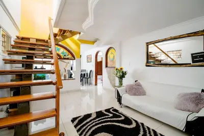 a living room with a staircase and a white couch at HOMEthel in Cartagena de Indias