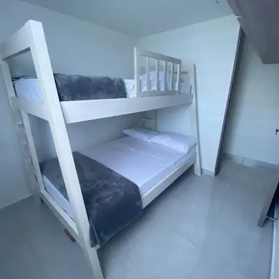 a white bunk bed sitting in a room at Hermoso Apartamento en Coveñas en unidad residencial in Coveñas