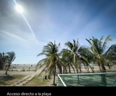 a volleyball court on a beach with palm trees at Apartamento con excelente vista al mar Dos alcobas los Morros in Cartagena de Indias