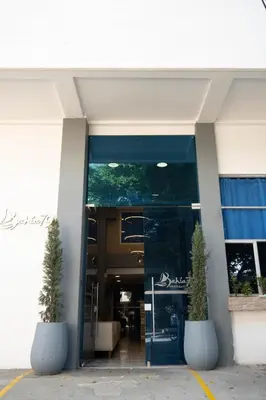 an entrance to a building with two potted plants at Suite con balcón cerca al centro Cartagena in Cartagena de Indias